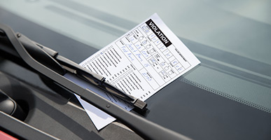 Traffic ticket placed on a car windshield