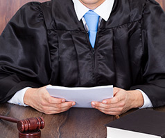 Judge holding papers on bench