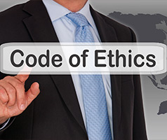 Man pointing at words Code of Ethics