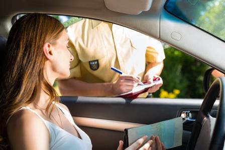 Woman getting a ticket from a police officer