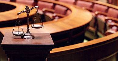 scales of justice in an empty court room