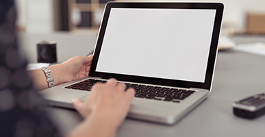 man typing on a laptop