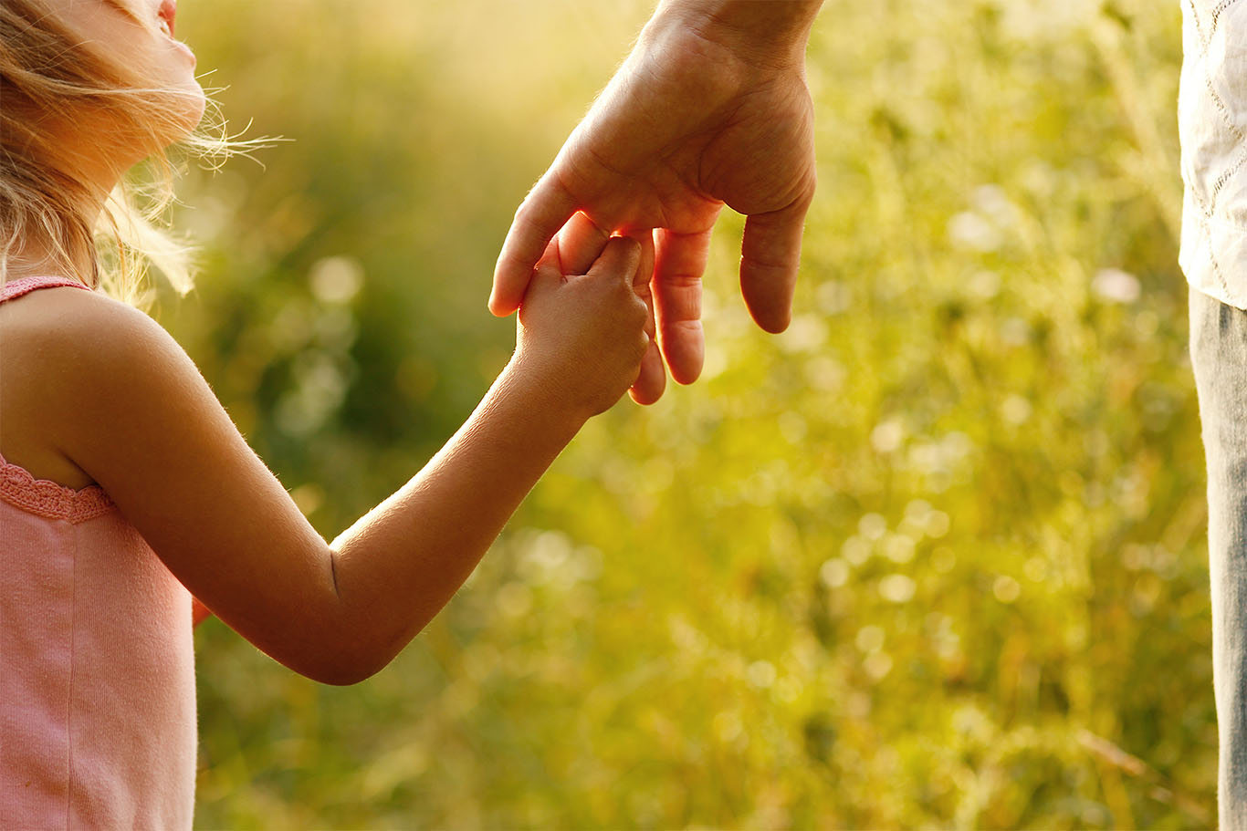 Child holding guardians hand