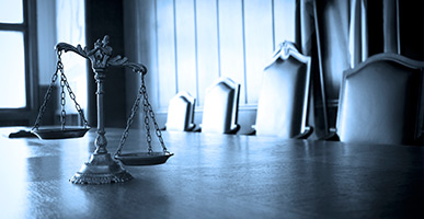 Courtroom with scales of justice on a desk