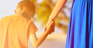 boy holding mom's hand