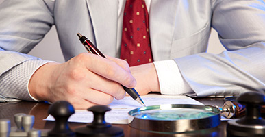 Man in a suit filling in a form