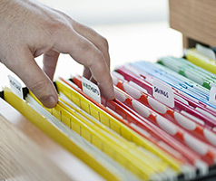 Person looking through a filing cabinet